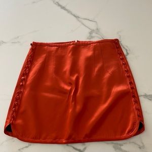 Orange silk skirt with buttons down both sides